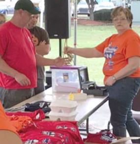 Marilyn Riley volunteer at TShirt/ BBQ Plate Lunch Booth Image